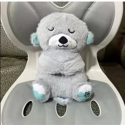 Doudou loutre la peluche loutre qui respire dort au fauteuil